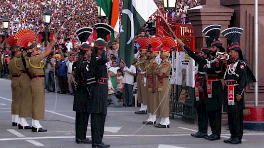 Border guards on both sides orchestrate a parade to lower the flags. 